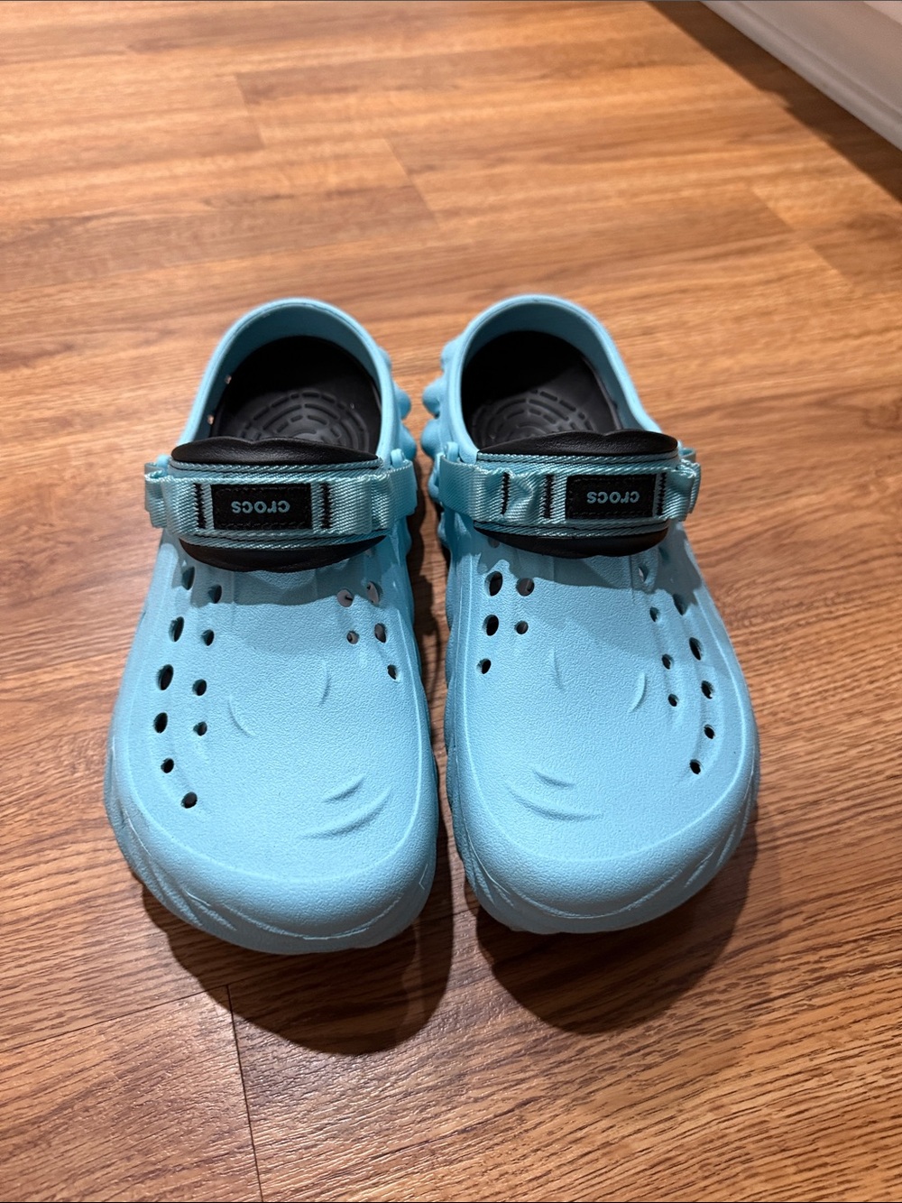 CROCS mens Light Blue Croslite Clogs with Black Strap